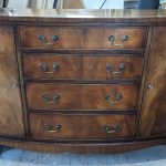dark wooden bow front cabinet