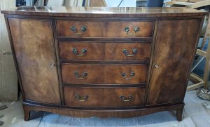 dark wooden bow front cabinet
